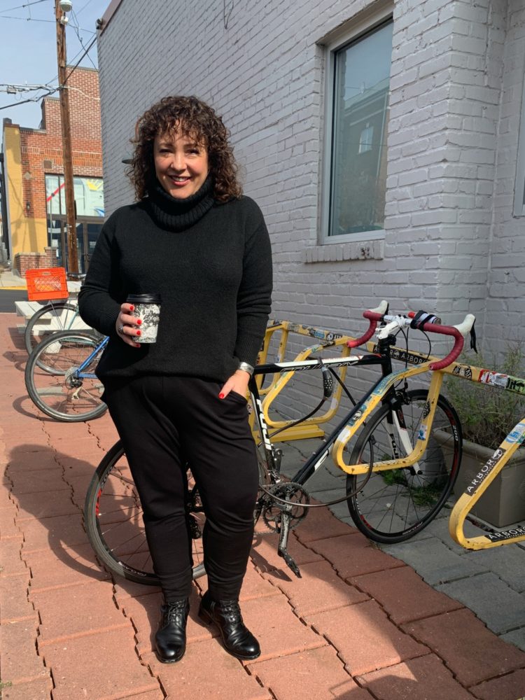 black tunic sweater with a turtleneck styled with knit joggers