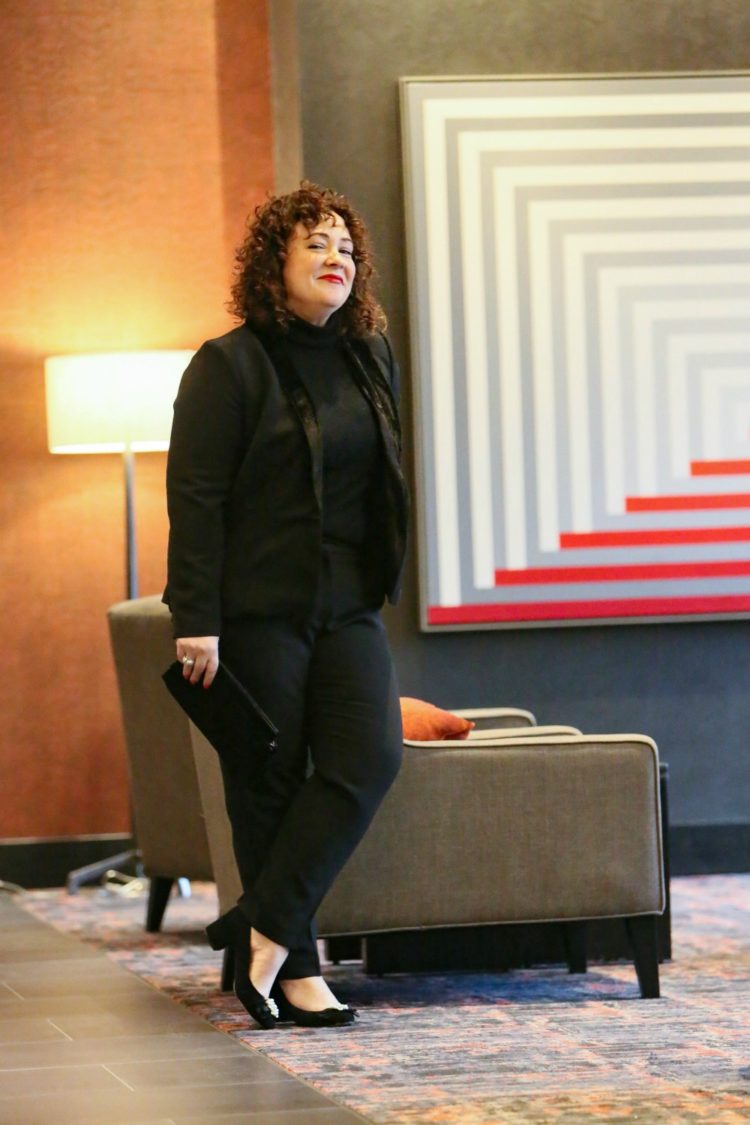 woman in a black pantsuit and black turtleneck