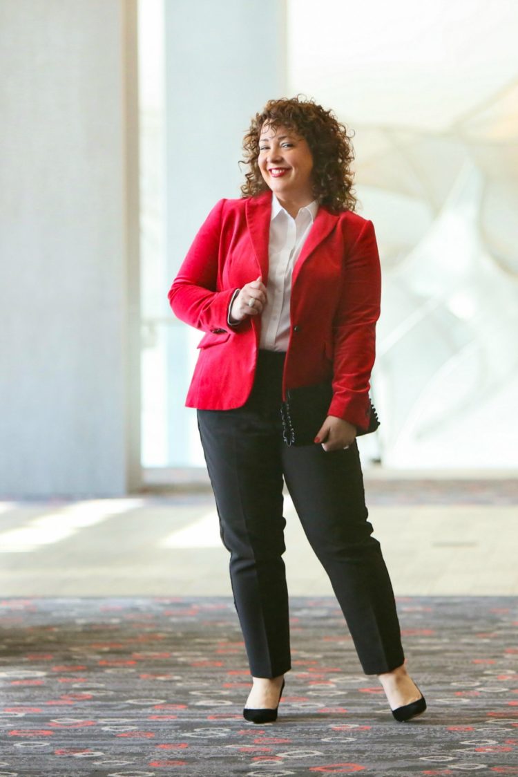 Alison smiling n a red blazer with white shirt and black ankle pants