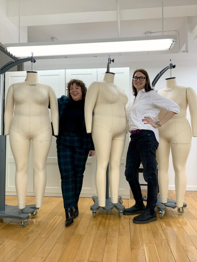 Alison Gary of Wardrobe Oxygen and Shanna Goldstone of Pari Passu standing in the Pari Passu NYC studio with three plus sized dress forms