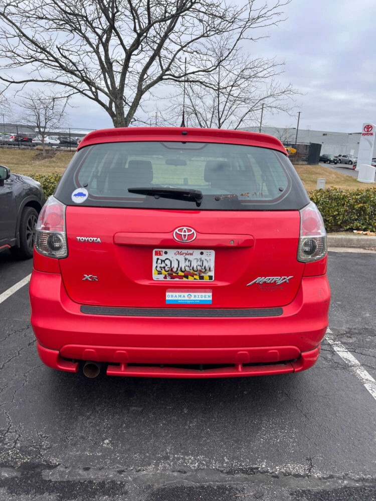 the back of a red Toyota Matrix with an Obama Biden bumper sticker