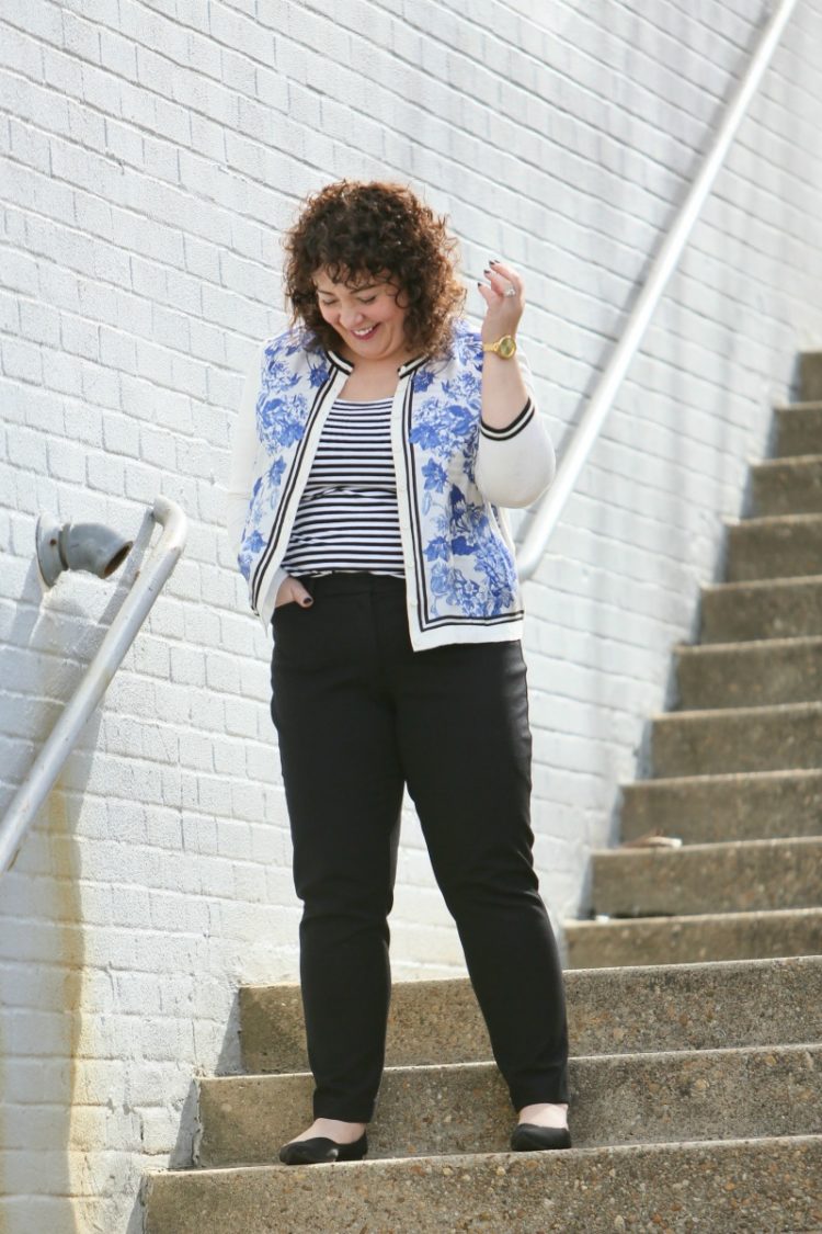 Woman in blue floral cardigan with black pants