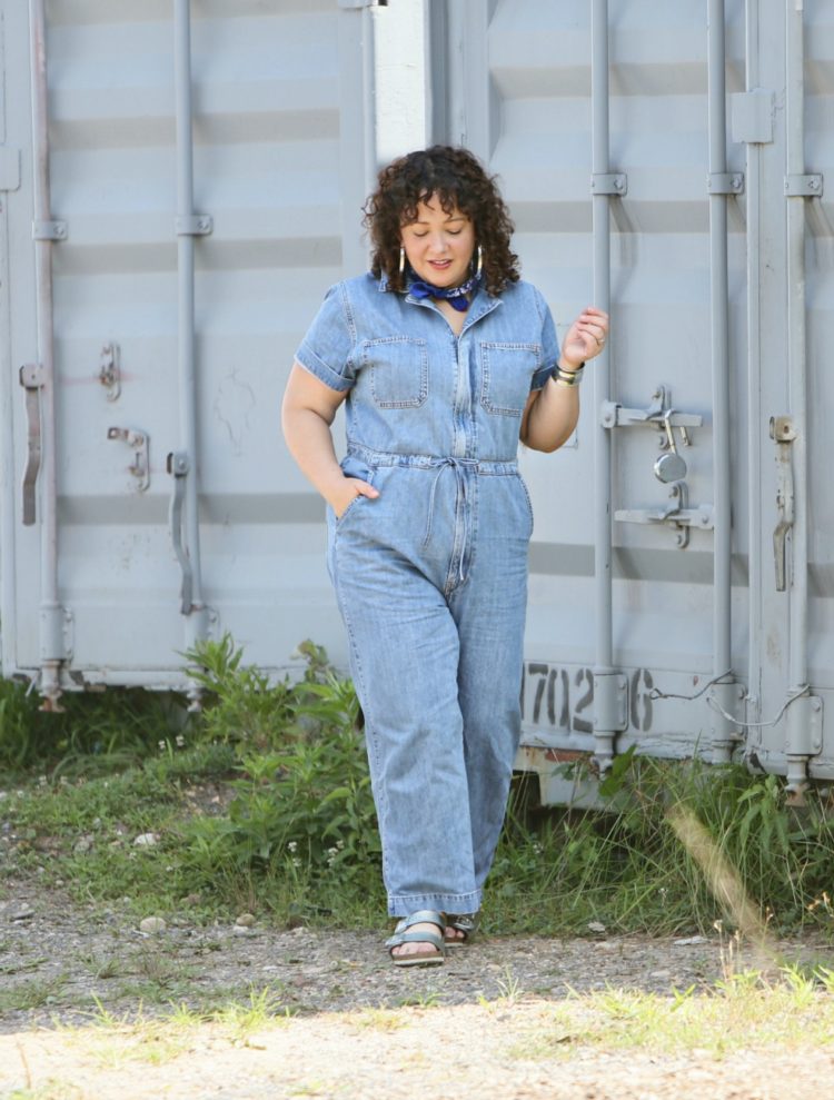 Woman in a short sleeve denim jumpsuit from Levi's styled with a blue bandana, silver Jenny Bird hoops, and silver Birkenstock sandals