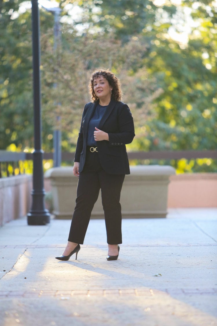 Alison Gary of Wardrobe Oxygen wearing a black blazer and trousers and a navy blouse from Universal Standard.