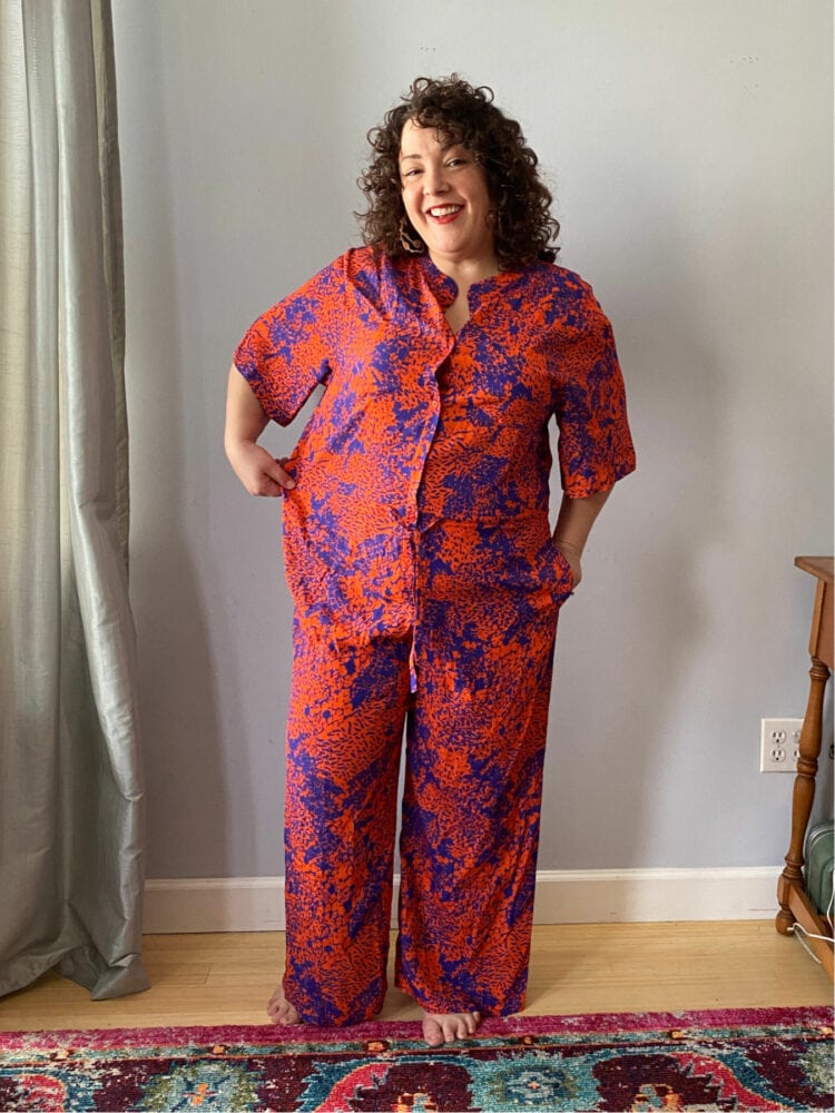 Alison Gary of Wardrobe Oxygen in The Kit NYC Issa jumpsuit pulling the jumpsuit to the side to show lack of space in a size XL jumpsuit