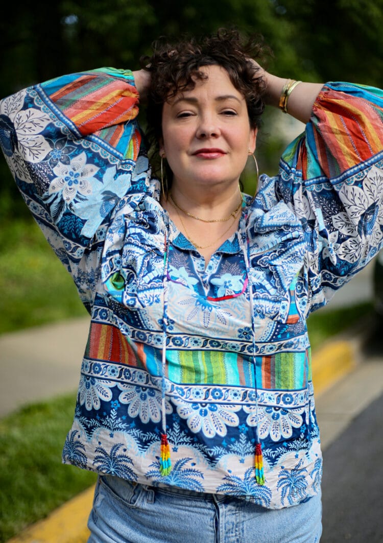 Closeup of Alison's Farm Rio top showing the rainbow beaded tassels and colorful stripes against a blue and white ground