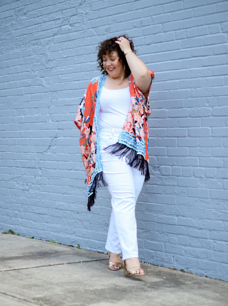 Switch Up Your Wardrobe with 3+ Great Summer Ruanas from Chico's 1 Alison in an orange and blue linen ruana with white jeans and a white tank and gold Margaux Uptown sandals