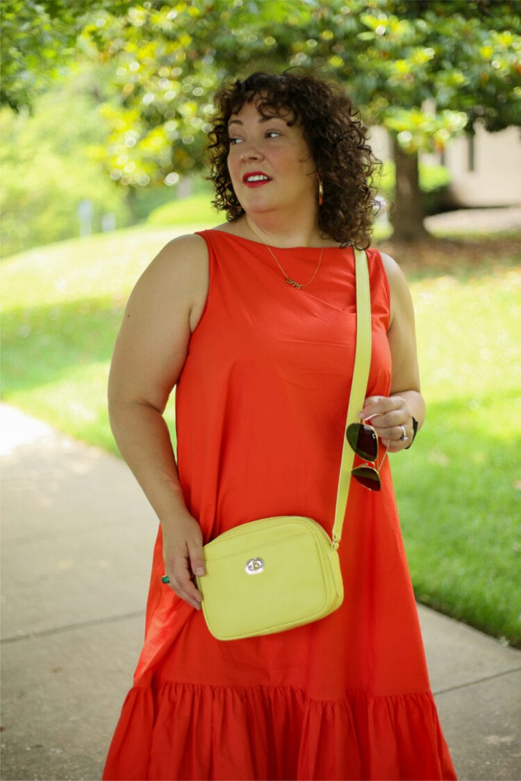 A closeup of the Talbots camera bag in lemon yellow that Alison is wearing as a crossbody