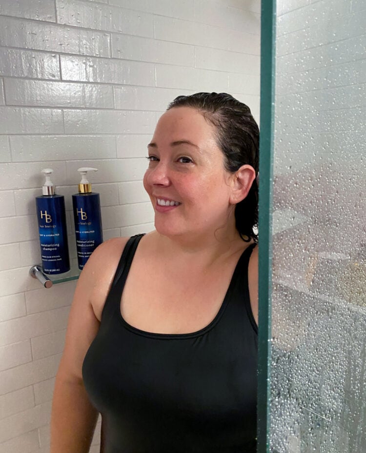 Alison of Wardrobe Oxygen in the shower washing her hair with Hair Biology Moisturizing shampoo and conditioner