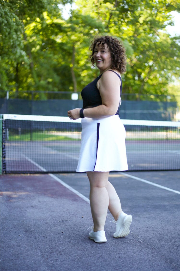 Alison in a black tank and white Talbots skort