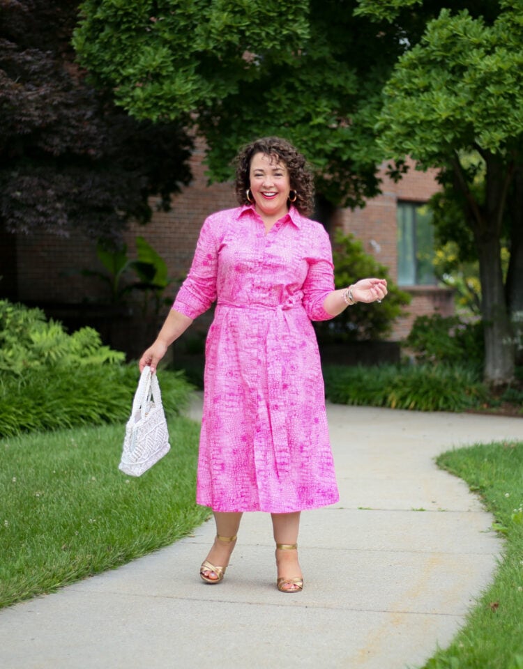 Wardrobe Oxygen wearing a pink poplin calf length belted shirtdress with a vintage white handbag and gold heeled sandals