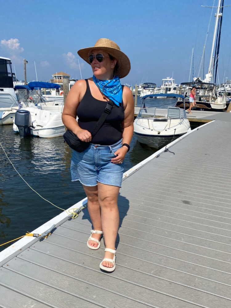 Alison Gary of Wardrobe Oxygen at the Davis Park marina wearing a black Lands' End Tugless Tank swimsuit and a pair of denim cutoff shorts