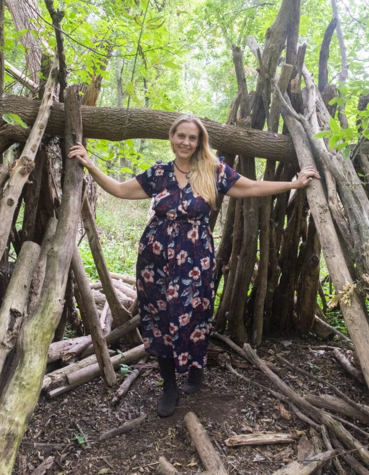 Woman with long blonde hair in the navy floral Dawn dress from Christy Dawn