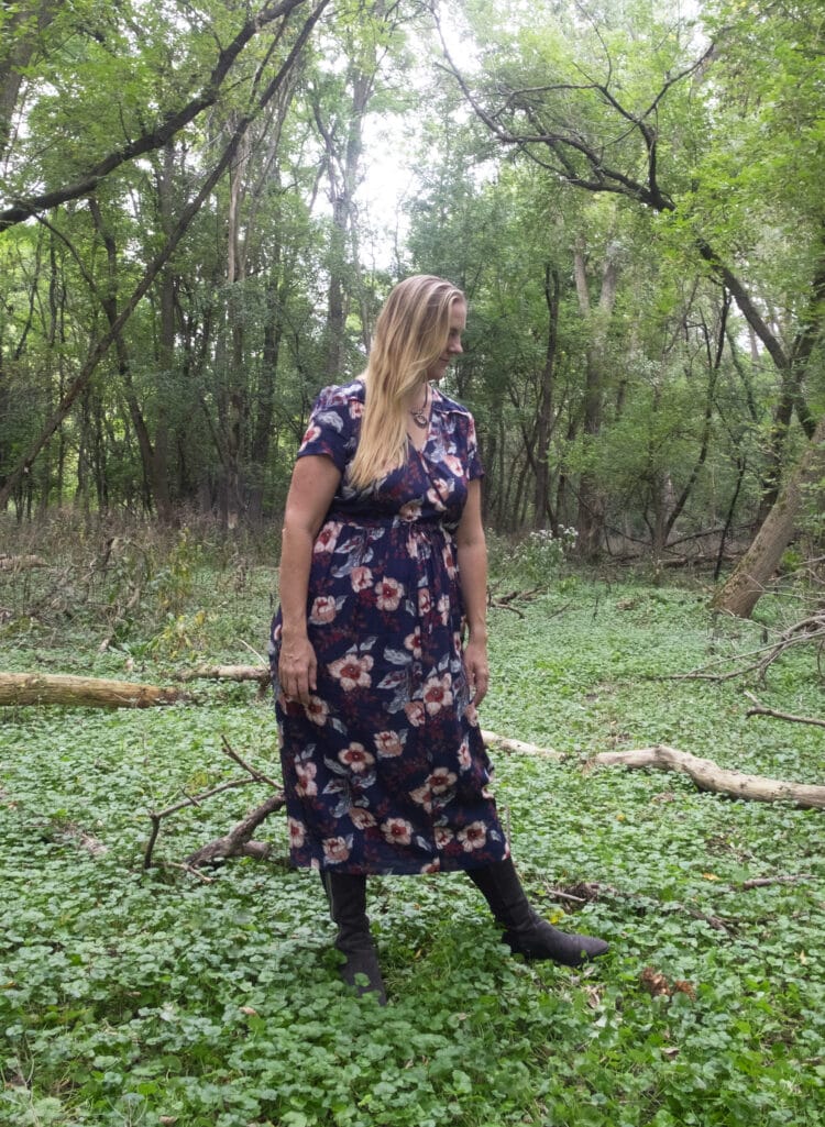 Woman with long blonde hair in the navy floral Dawn dress from Christy Dawn