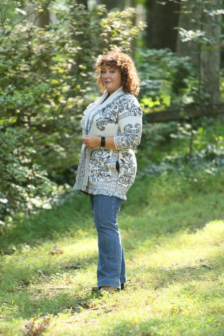 Wardrobe Oxygen in a Chico's belted cardigan sweater with a blue print on ivory