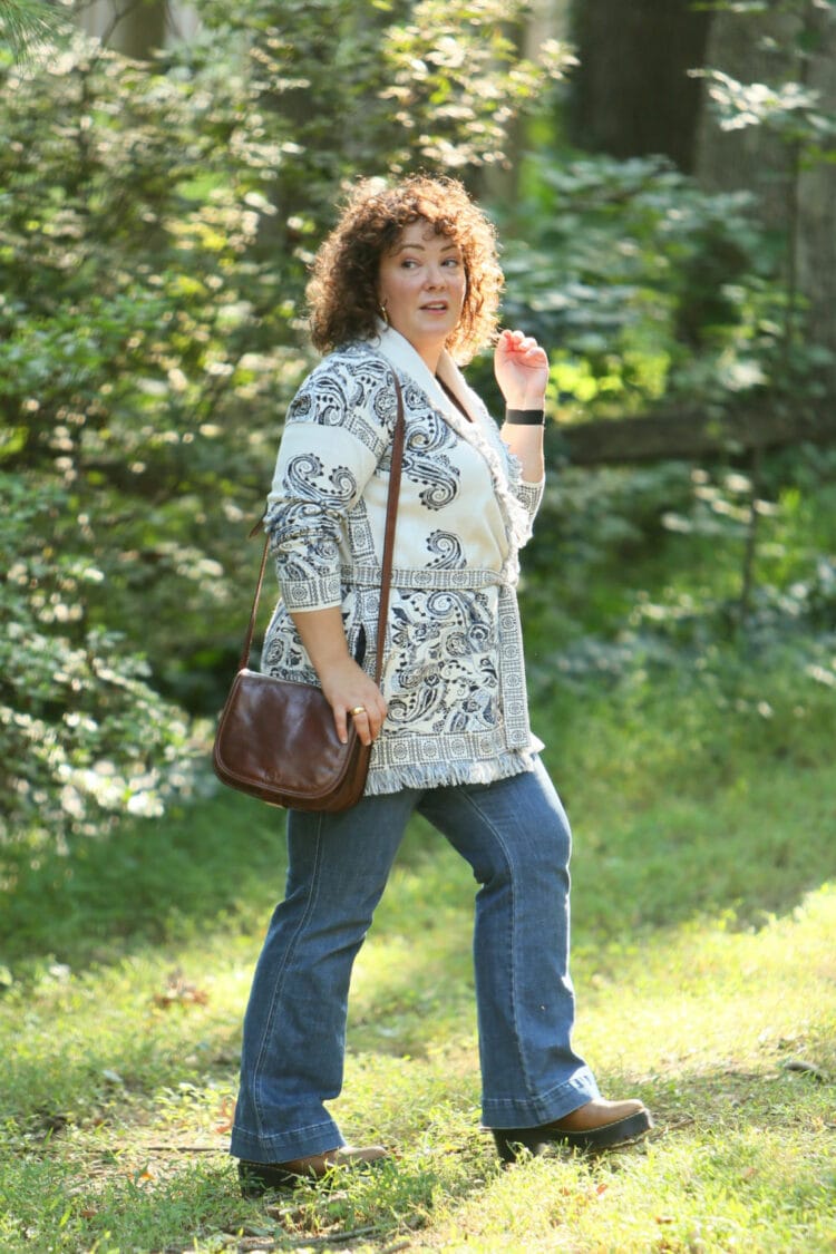 Wardrobe Oxygen in a Chico's belted cardigan sweater with a blue print on ivory