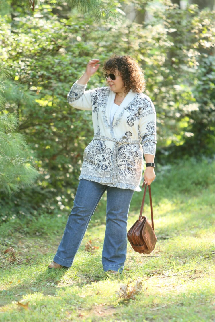 Wardrobe Oxygen in a Chico's belted cardigan sweater with a blue print on ivory