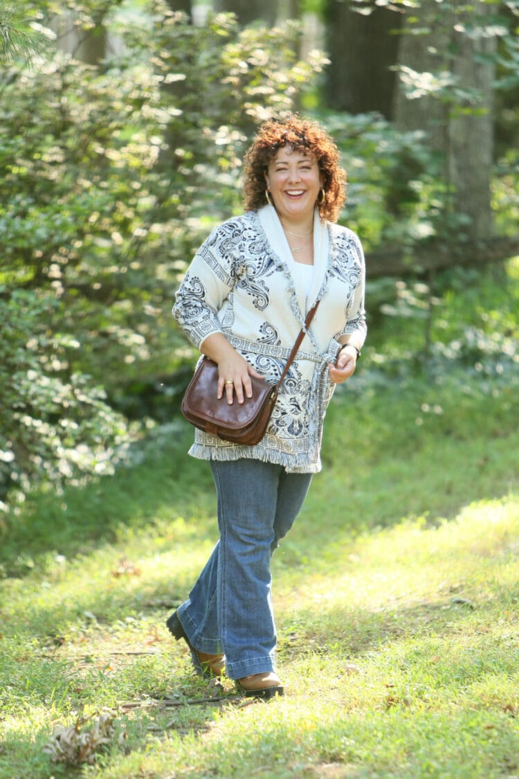 Wardrobe Oxygen in a Chico's belted cardigan sweater with a blue print on ivory