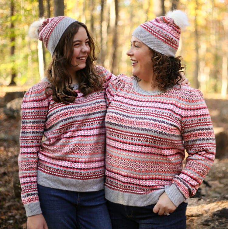 Alison and her daughter hugging and smiling at one another. They are wearing matching Talbots Fair Isle sweaters and knit caps with white furry pom poms on top.