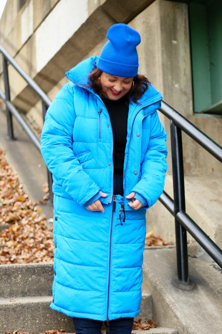 Alison zipping up the Universal Standard 4-in-1 hybrid puffer