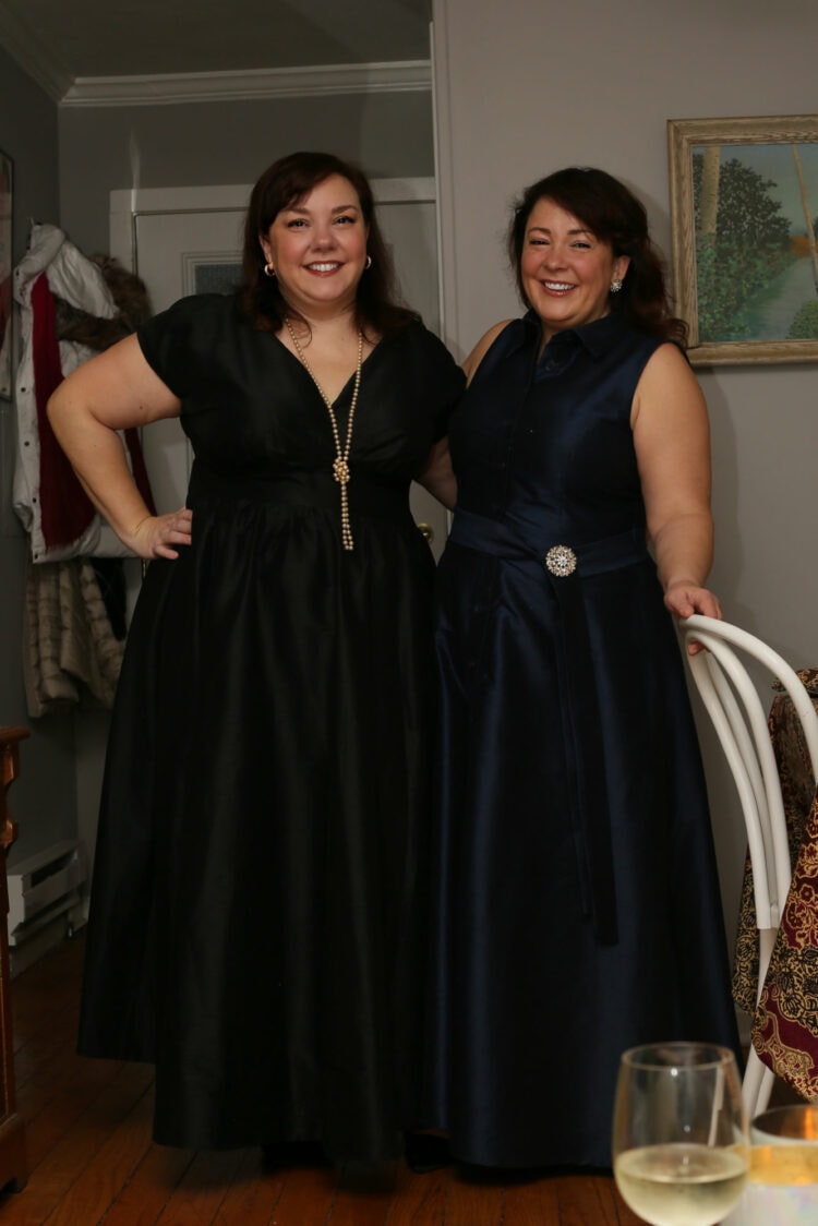 Two women in their 40's wearing dark colored full-length dresses out of silk dupioni, created by the apparel brand eShakti. They are sisters Alison Gary and Debbie Ashpes.