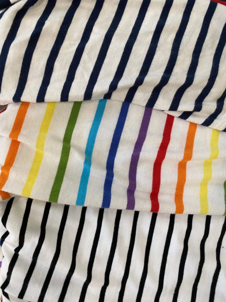 Three striped tops layered over one another