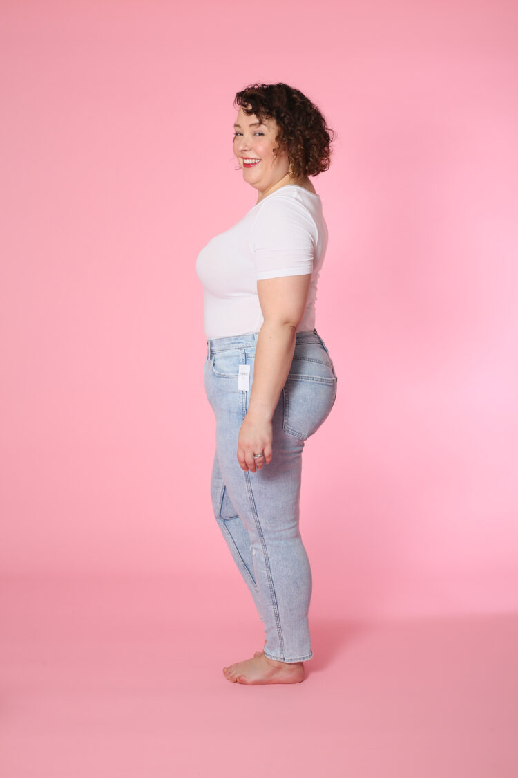 Side view of Alison in size 32 short in the Slim Mid Rise Jean.