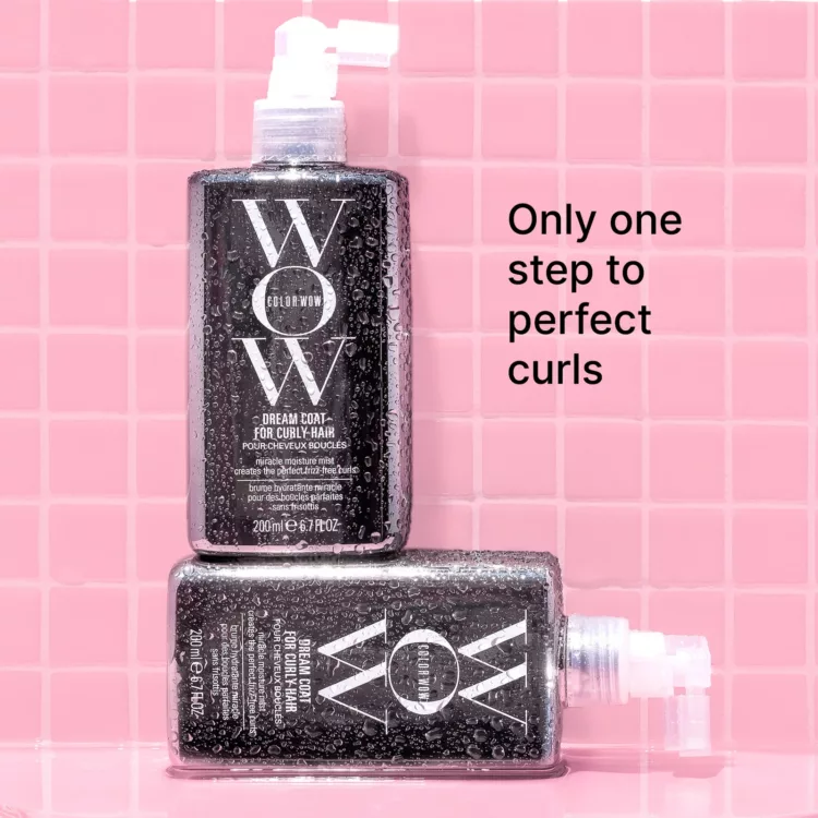 two bottles of ColorWOW Dream Coat for curly hair in a shower with pink tile