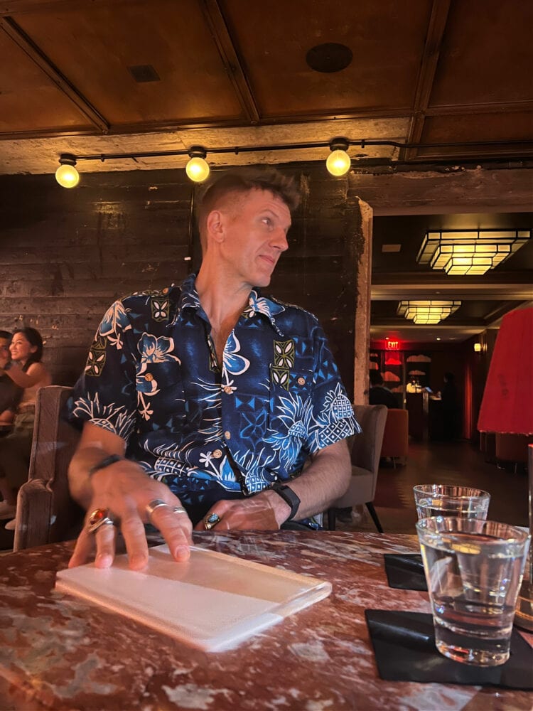 My husband Karl in a vintage blue Hawaiian shirt at a table a Silver Lyan, the basement bar in the Hotel Riggs Washington DC