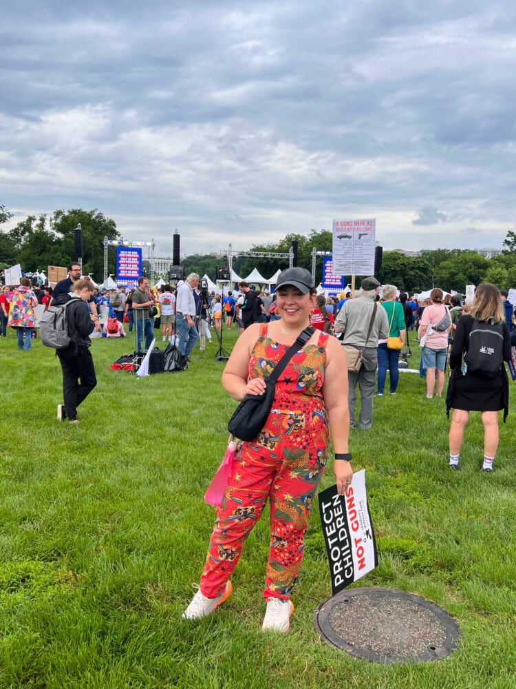 Alison Gary in an orange cotton jumpsuit and black baseball cap at the 2022 March for Our Lives anti-gun rally in DC.
