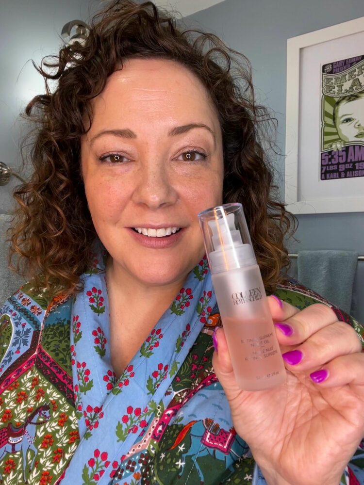 Alison Gary, the woman behind the over 40 style advice blog Wardrobe Oxygen, is holding a bottle of Colleen Rothschild Retinol Supreme Oil