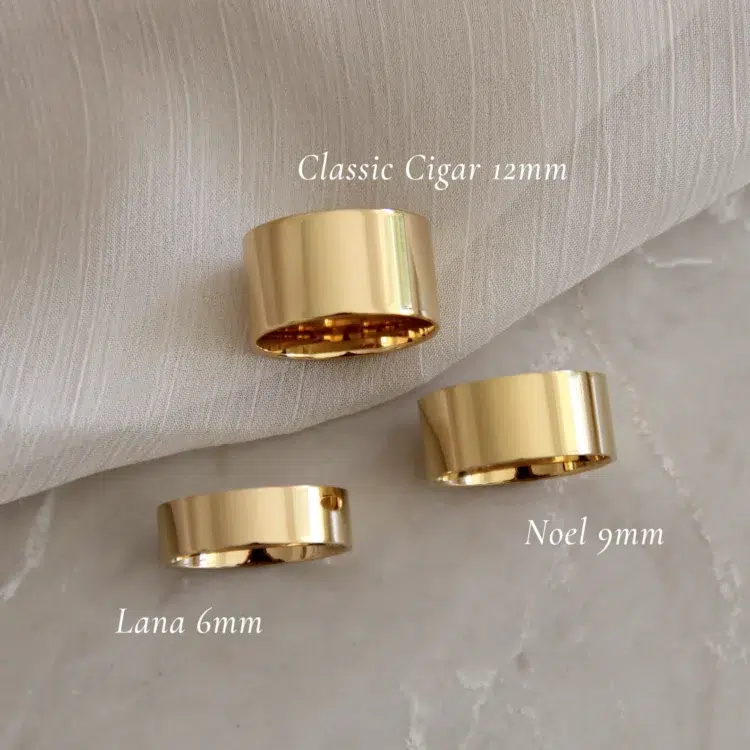 Image showing three gold cigar band style rings of various widths