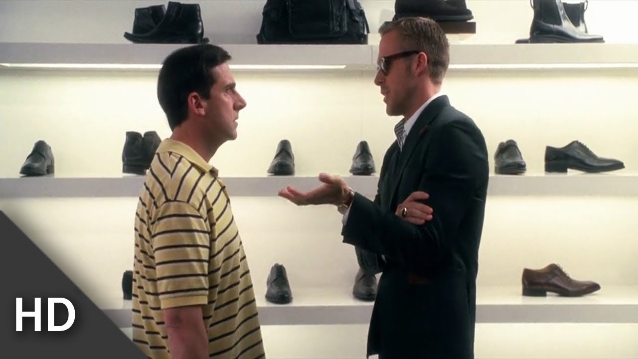 screenshot from the movie Crazy Stupid Love shows Ryan Gosling and Steve Carell talking to one another in a shoe store.