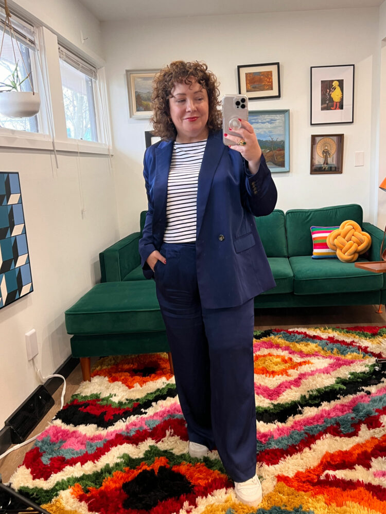 Alison in a navy pantsuit from Ann Taylor and a Navy and white stripe Breton top from Amazon, standing in her office