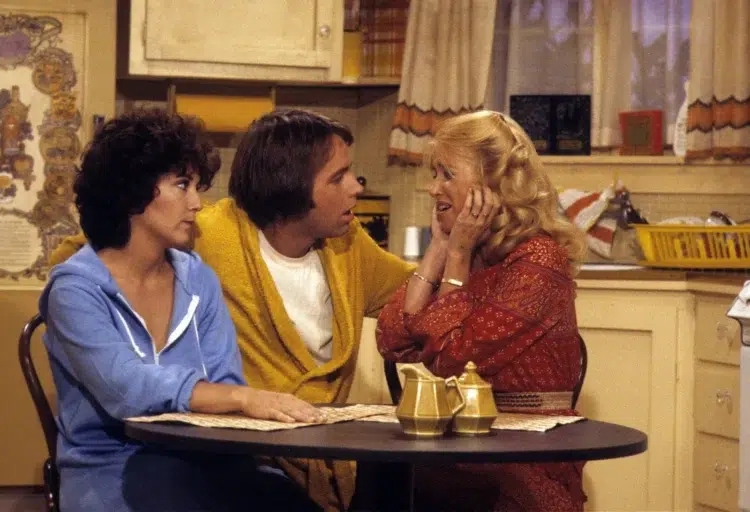 scene from the TV show, Three's Company featuring Janet, Jack, and Chrissy in their kitchen