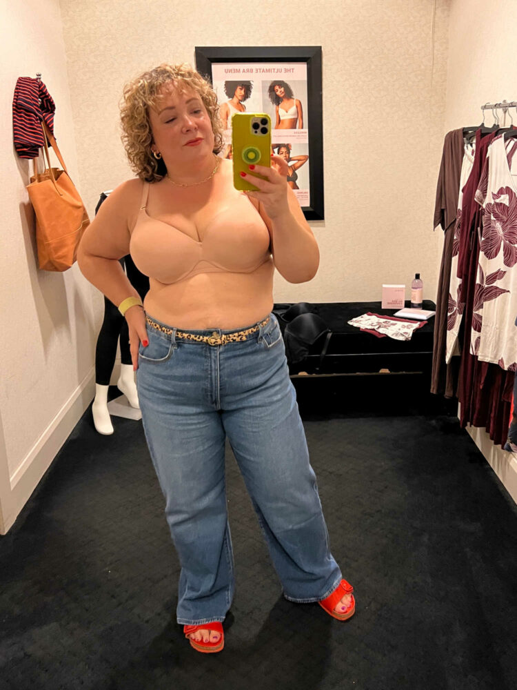 Alison of Wardrobe Oxygen in a Soma Intimates boutique fitting room wearing jeans and the Soma Bodify Perfect Coverage Bra