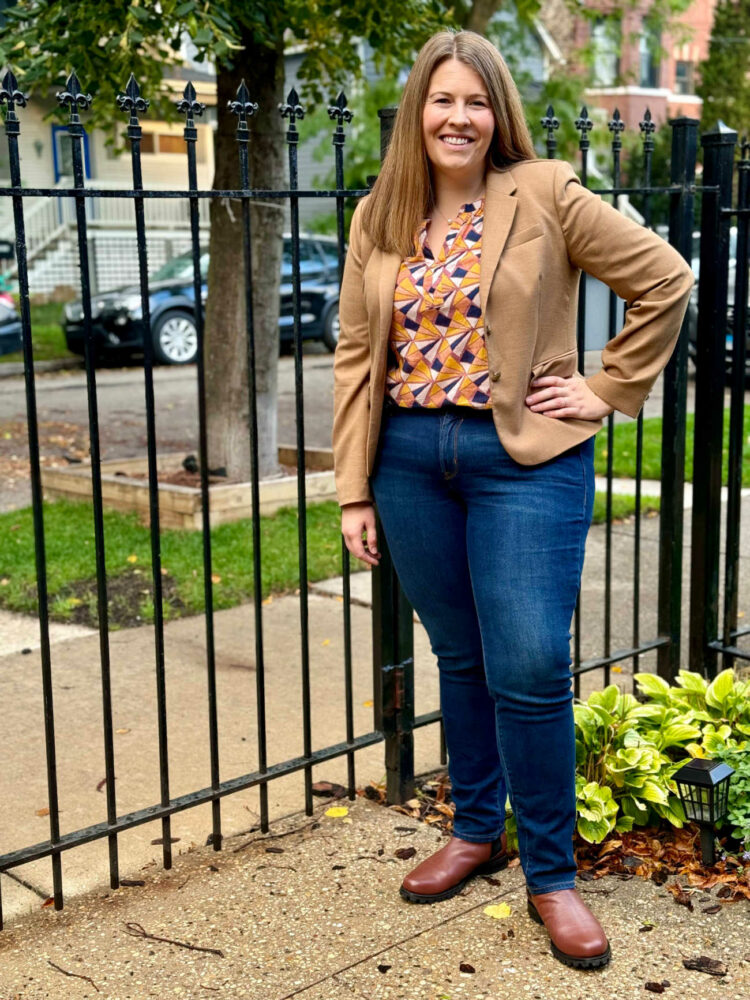 Woman in a tan blazer and printed shell over dark straight leg jeans styled with Poppy Barley Chelsea boots