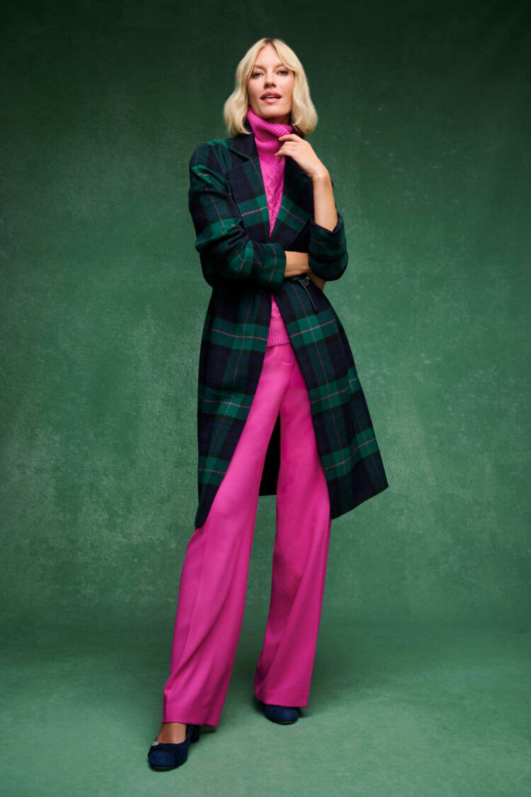 bright pink turtleneck sweater and wide leg pants from Talbots under a green and black plaid overcoat.