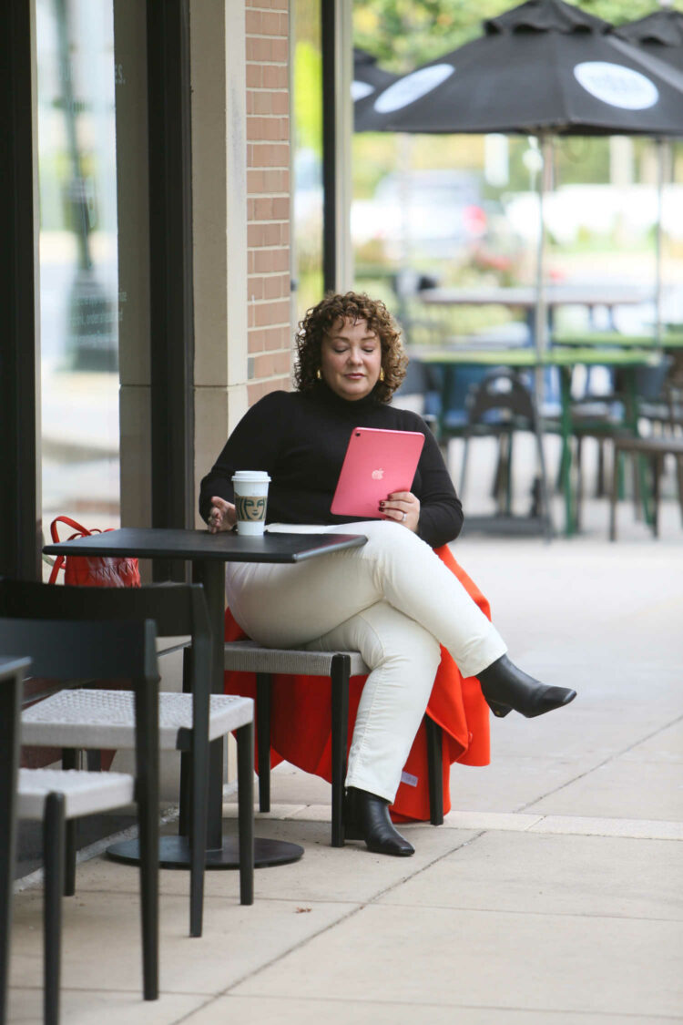 How to Style Ivory Courdory Pants for Grown Women 1 Alison Gary of Wardrobe Oxygen wearing ivory corduroy pants from Talbots as she sits at a coffee shop drinking a latte and reading from her iPad