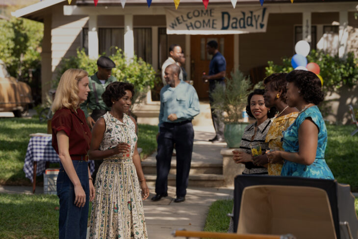 A scene from the miniseries Lessons in Chemistry where protagonist Elizabeth visits her neighbor Harriet's party welcoming back her husband from the Army