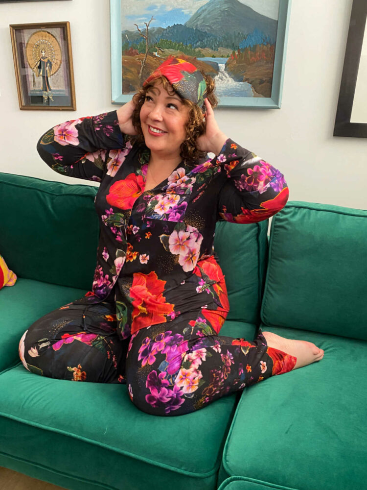 Alison of Wardrobe Oxygen in Soma Cool Nights Pajamas in the Drama Blooms print with the matching sleep mask on her head