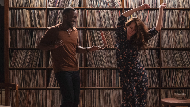 Scene from the film LEave the World Behind where Mahershala Ali and Julia Roberts dance in front of a wall of records