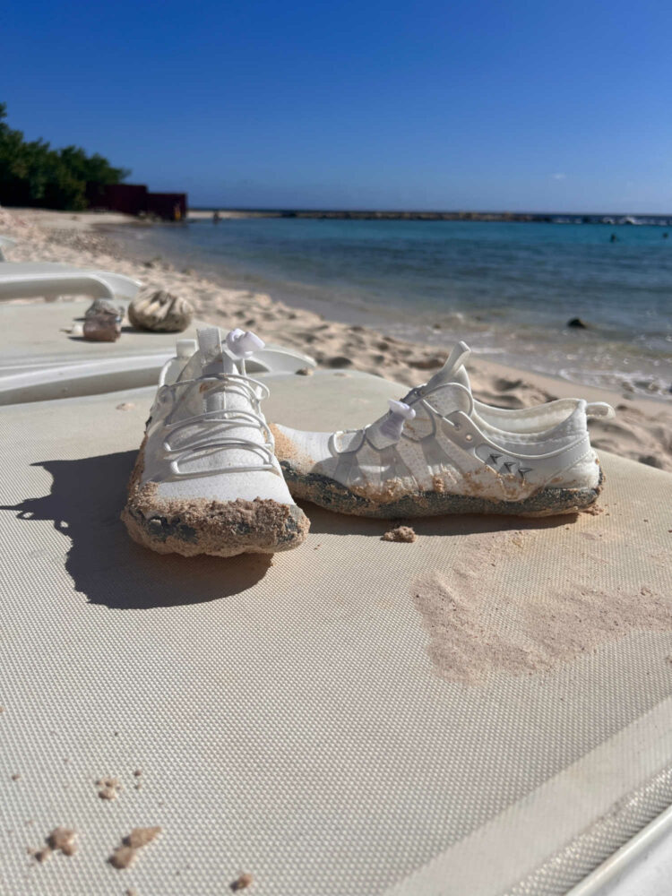 white water shoes sitting on a lounge chair on a beach