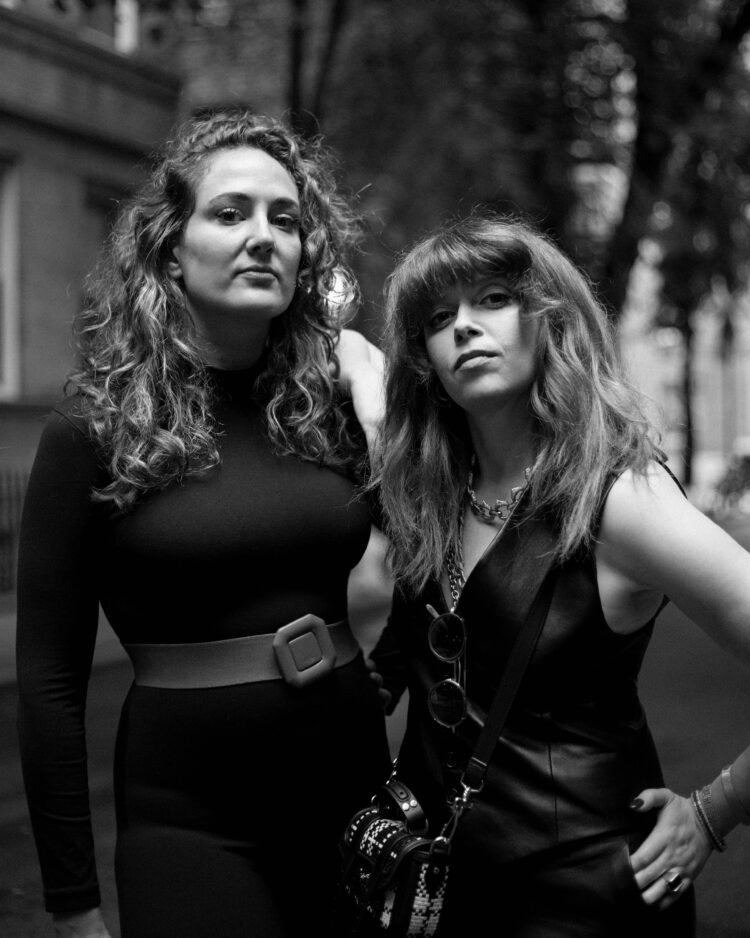 A black and white photo of Jacqueline Novak and Natasha Lyonne, making tough faces at the camera