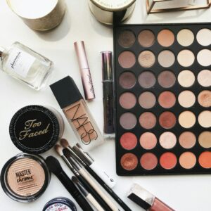 a variety of makeup products o a white table