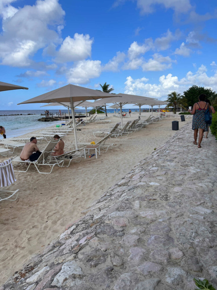 walking on a stone path that separates the Curacao Marriott Beach Resort from the private beach