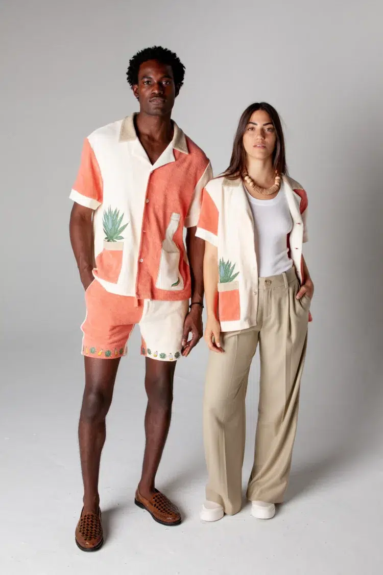 tombolo cabana shirts worn on a man with matching shorts and a woman, open over a tank and khaki pants