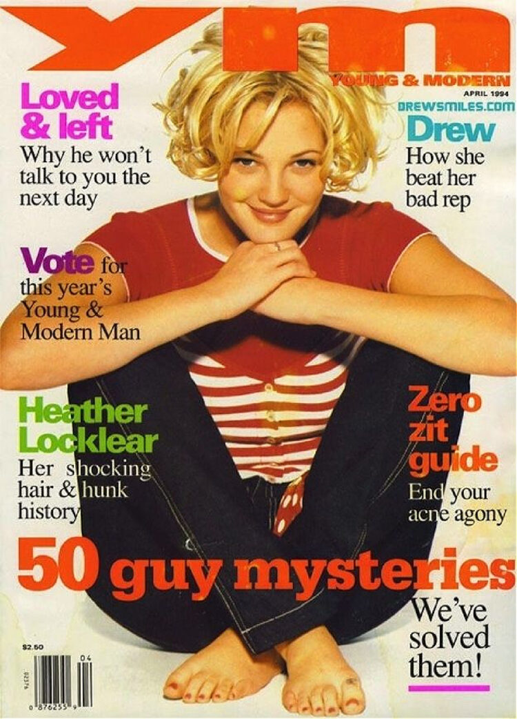 vintage ym magazine from 1994 featuring drew barrymore on the cover. She has a blonde chin-length curly hairstyle, sitting on the ground wearing dark jeans and a red and white striped t-shirt