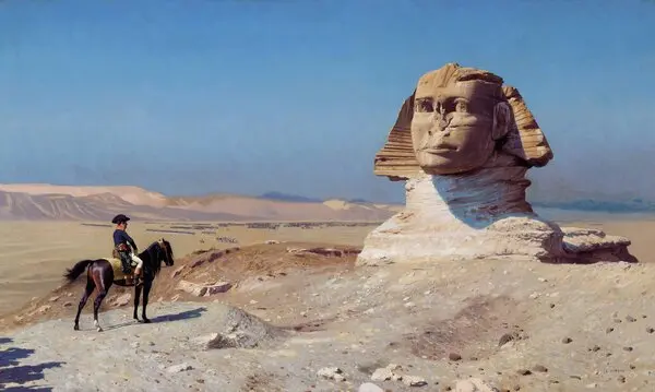a scene from the 2023 film Napoleon where Napoleon, played by Joaquin Phoenix, is on a horse looking at the Sphinx in Egypt