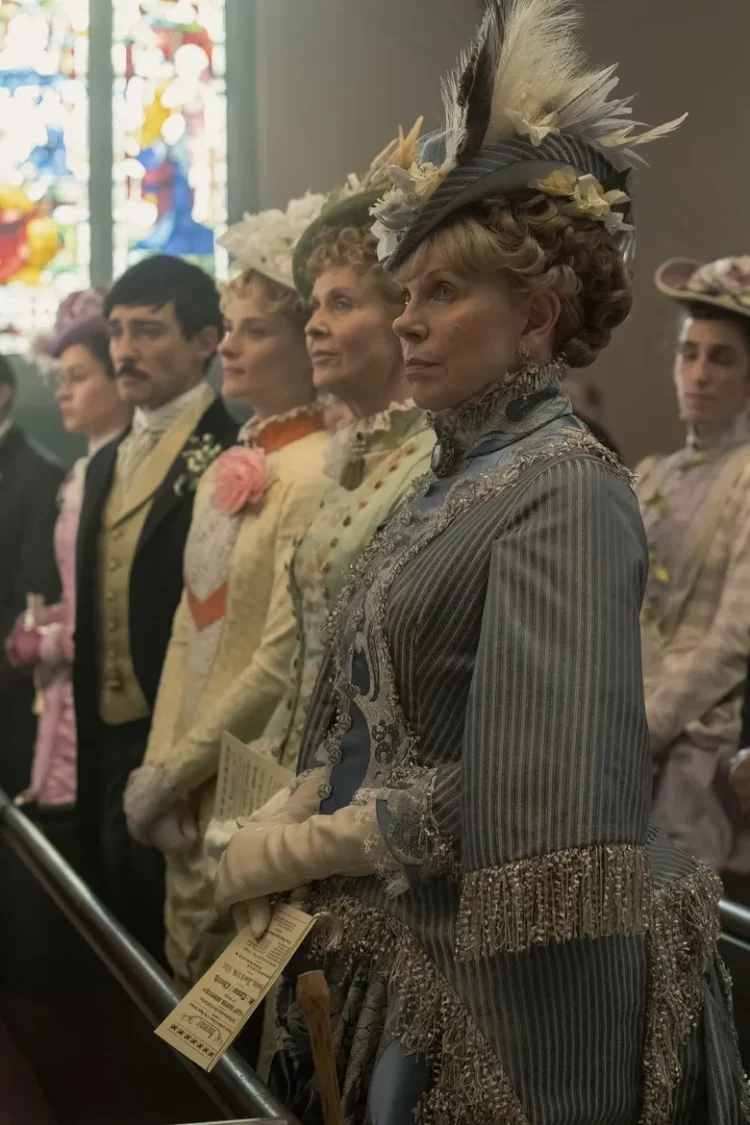 a scene from the gilded age where the characters are standing in a pew at church on Easter Sunday